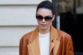 Kendall Jenner wears white top, brown leather double blazer, brown suede Hermès bag, black sunglasses, outside Schiaparelli, during Haute Couture Spring-Summer 2025 as part of Paris Fashion Week on January 27, 2025 in Paris, France.