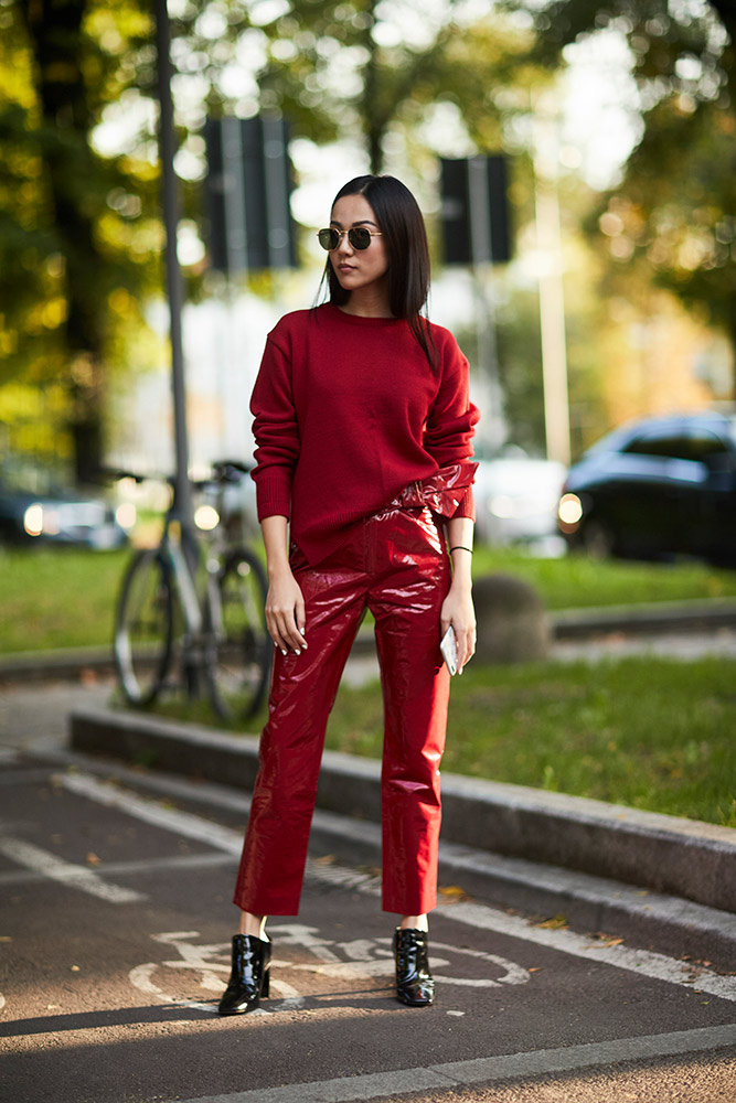 milan street style red sweater red vinyl cropped trousers black ankle boots hint of leg